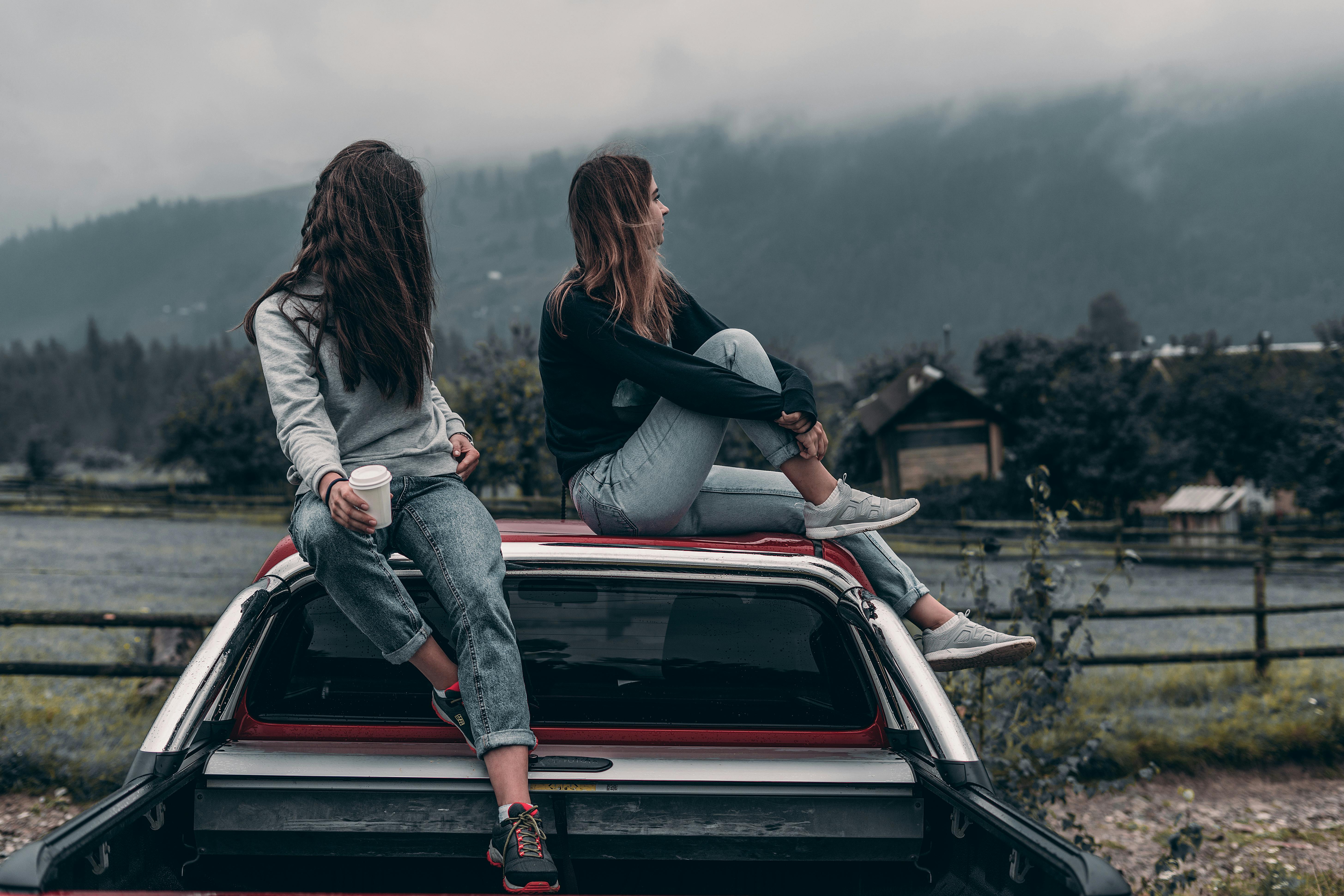 Two people by car